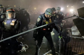 Polícia začala rozoberať protestný stanový tábor na Kalifornskej univerzite v Los Angeles, demonštranti sa bránili dáždnikmi (video)